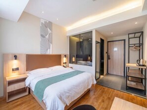 A modern hotel room with a large bed, bedside tables, a glass shower enclosure, and a small kitchenette area. - Greentree Inn Wuxi Quanshan Center Express Hotel (Wuxi)