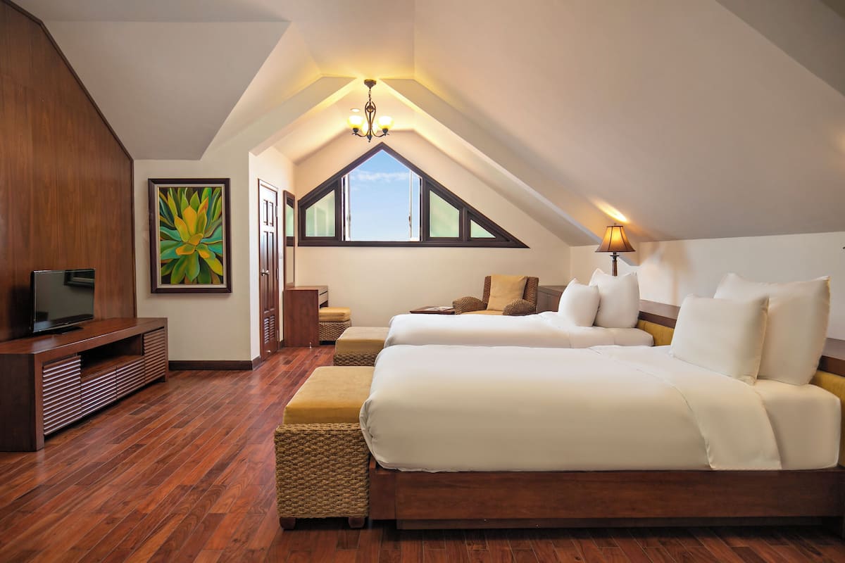 A bedroom with two beds, a TV, wooden flooring, a painting, and a window with a view.
