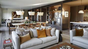A modern living room with a sofa, coffee table, and dining area.