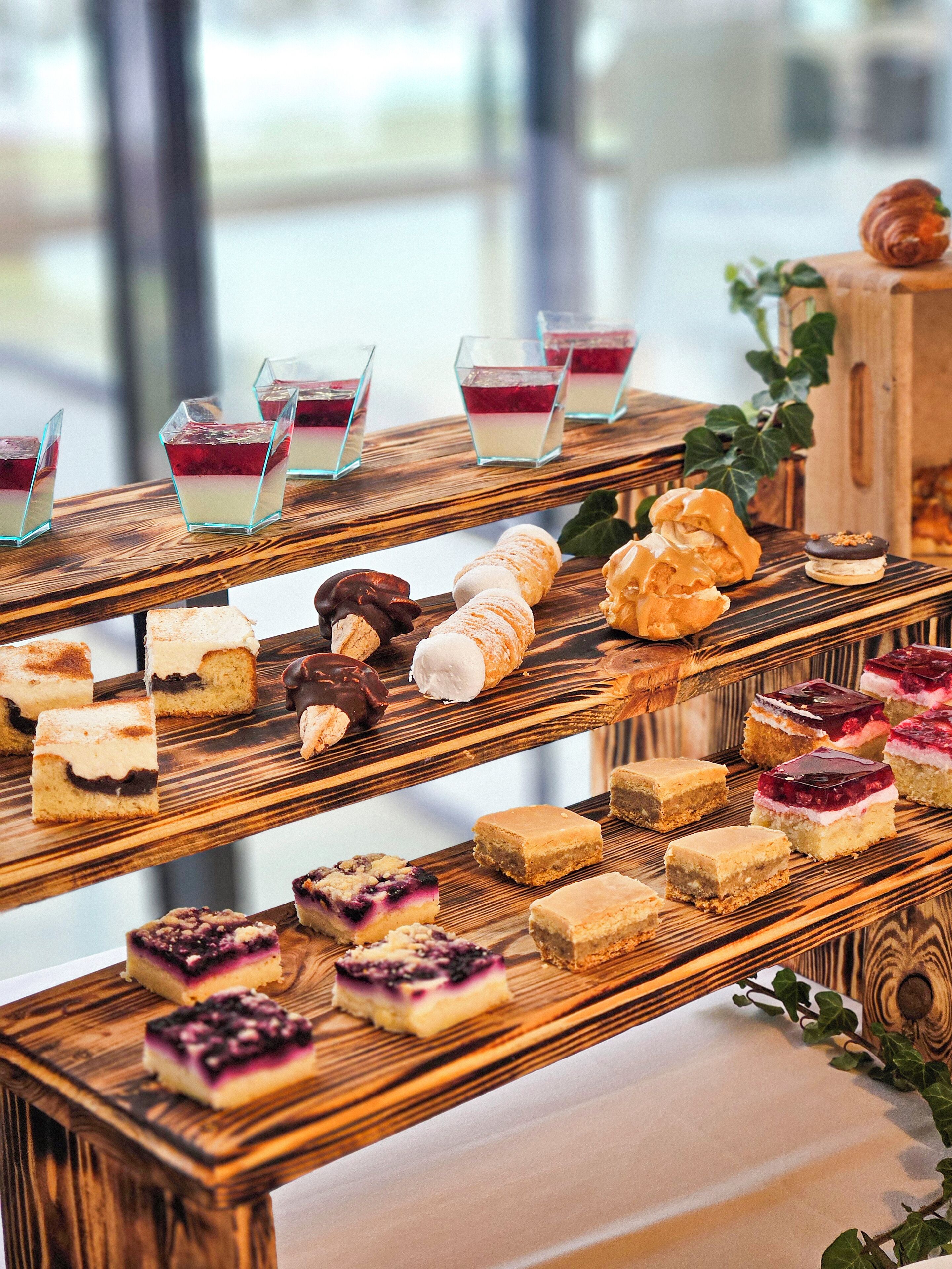 A multi-tiered dessert display with various pastries and desserts.