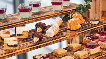 A multi-tiered dessert display with various pastries and desserts.