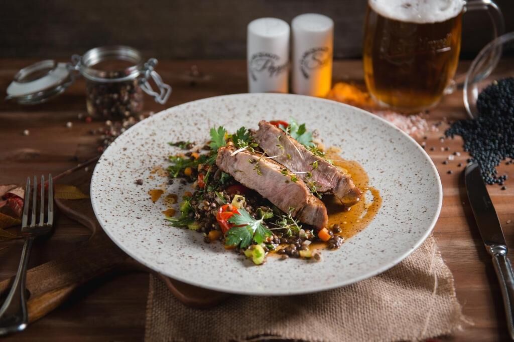 A plate of food with a fork and knife on the side.
