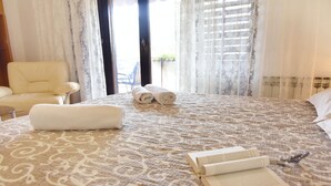 A hotel room with a large bed, two rolled towels, and an open book on the bed. - Apartment Elizabeta for couples near the sea and the center Umag (Umag)