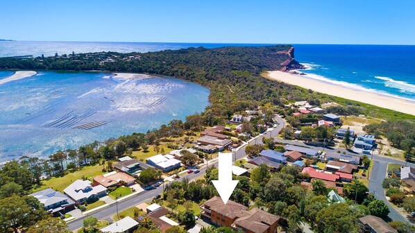 Stunning coastal neighborhood with a mix of homes, greenery, and ocean views.