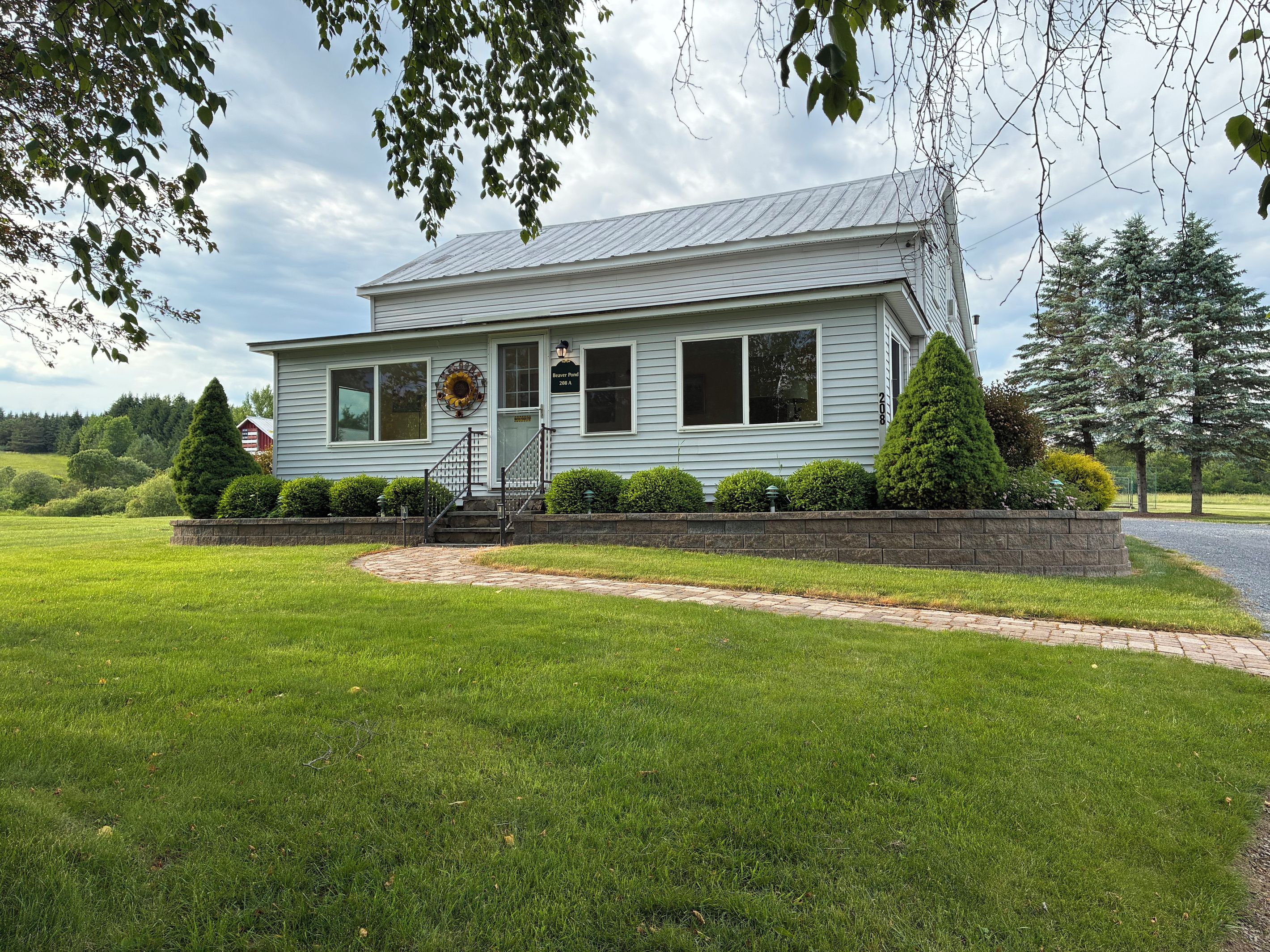 A single-story house with a front porch, a mailbox, and a well-maintained lawn.