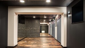 A hallway with a wooden floor, a brick wall, and a white pillar. - Kyriad Stargard (Stargard Szczecinski)