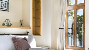 A neatly made bed with a fluffy pillow, a bedside table with a lamp, and a window with curtains. - Stunning 2BR Apt with Balcony Next to Queens Uni - Pass the Keys (Belfast)