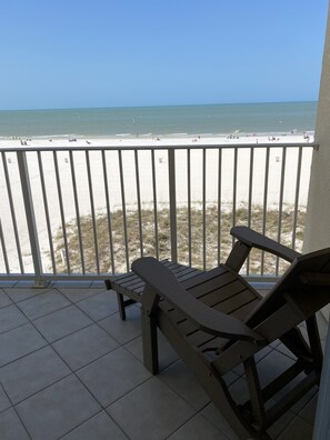 A balcony with a view of a beach.