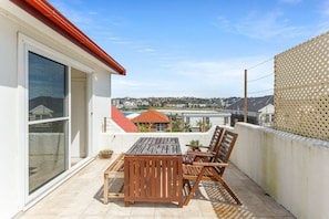 Enjoy a balcony with a table and chairs, offering a view of the city.