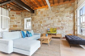 Relax in this stylish living room with a sofa, coffee table, and TV.