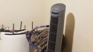 A room with a standing heater, a white radiator, and a black curtain on the wall. - GREAT PLACE TO STAY AT (Edmonton)