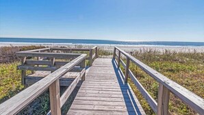 A wooden boardwalk leading to a beach with a clear sky. - Beach Club Villa 30 - Oceanfront! Pool! Walkout! (Isle of Palms)