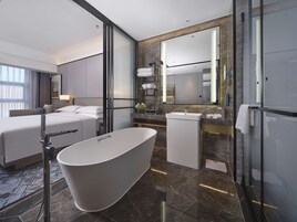 Deluxe Room, 1 King Bed | Bathroom | Separate tub and shower, rainfall showerhead, free toiletries