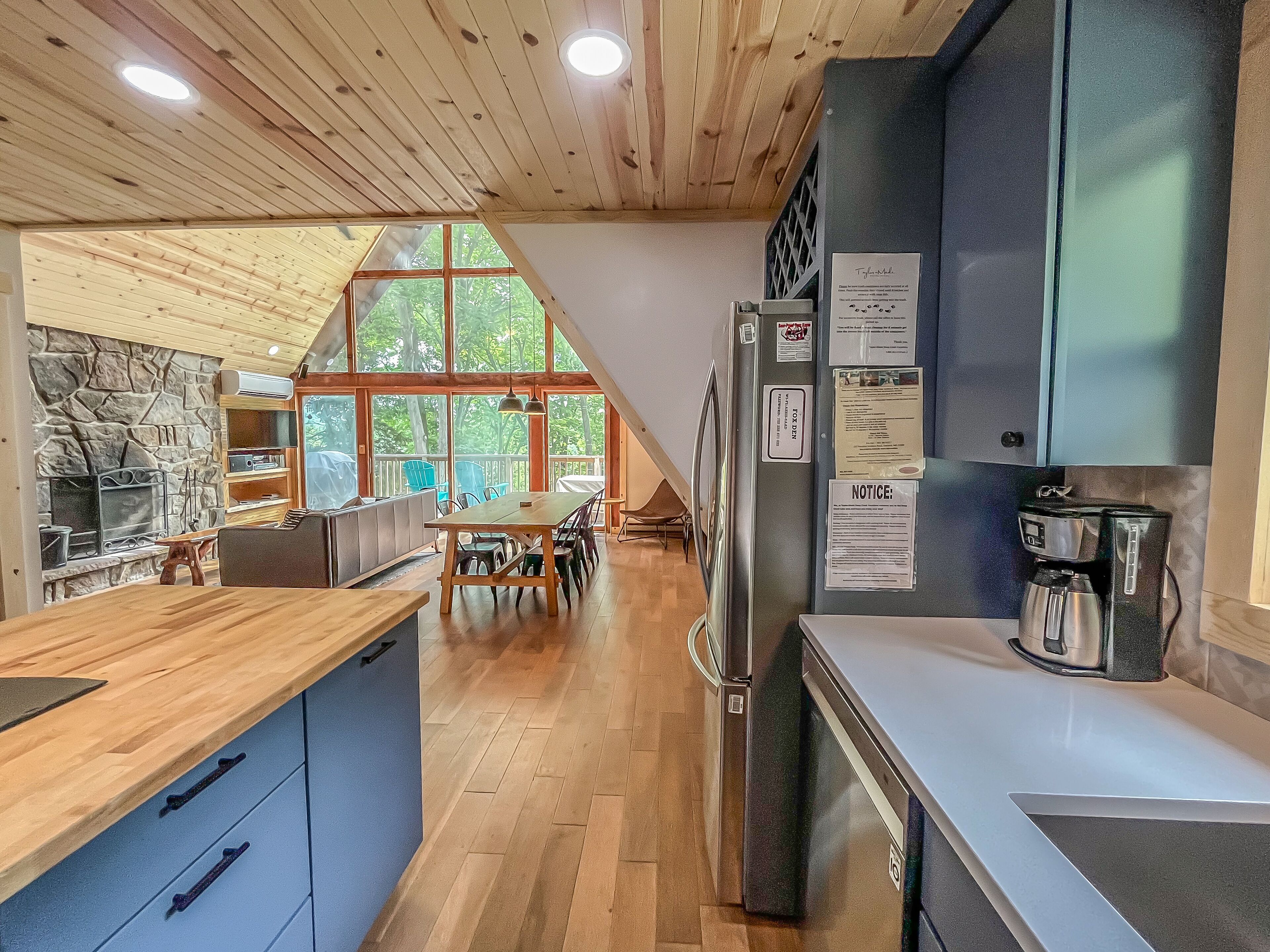 A modern kitchen with a large island, a built-in stove, and a coffee machine.