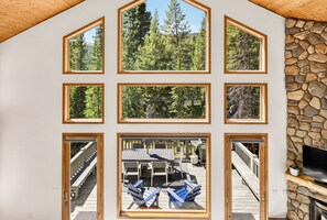 A cabin with multiple windows offering views of a forested landscape. - Spacious and Peaceful 5 Mins to Ski Area/Main St (Breckenridge)