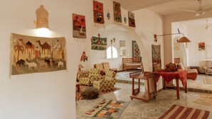 Una sala acogedora con alfombras estampadas, un sofá y una mesa de comedor.