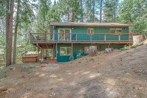 A two-story cabin with a balcony, surrounded by trees. - PRIVATE HOT TUB + ACCESS TO BLS RECREATION CENTER (Arnold)
