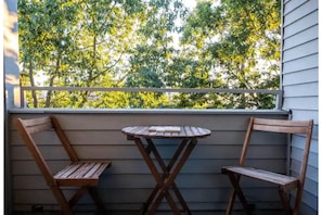 Enjoy a peaceful outdoor retreat with a patio featuring a wooden table and two chairs.