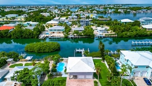 A residential area with houses, a swimming pool, and a marina. - One Particular Harbor ~ Waterfront Pool Home Near the Beach! (Marathon)