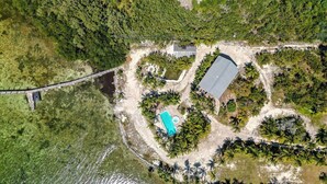 An aerial view of a property with a swimming pool, a large building, and a bridge. - Sunsets in Paradise~ Gulf Front Pool Home, 22' Dock, Kayaks, Bikes & Paddleboards (Marathon)