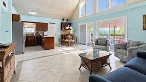 A spacious living area with a kitchen, dining table, and seating. - Kon Tiki ~ Private Waterfront Pool Home, 30' Dock (Marathon)