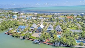 An aerial view of a resort with multiple buildings, a marina, and a beach. - Kon Tiki ~ Private Waterfront Pool Home, 30' Dock (Marathon)