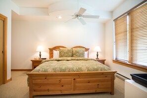 Cozy retreat with a single bed, ceiling fan, and comfortable seating area.