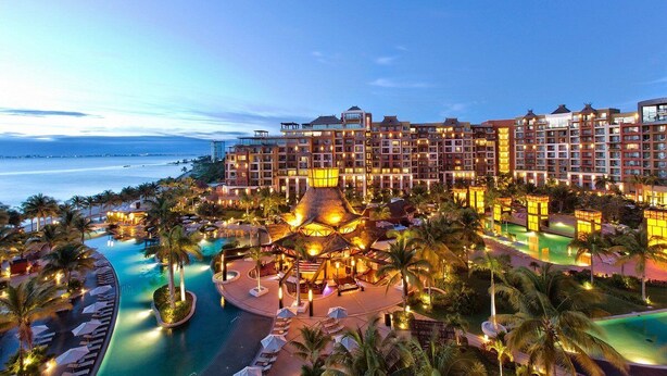 A resort with multiple swimming pools, palm trees, and a large building with balconies. - Cancun 5 stars Luxury Resort and Spa, 1 bedroom suite, 2 baths, sleep 4 (Punta Sam)