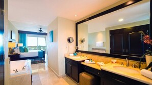 A modern bathroom with dual sinks, a large mirror, and a separate shower area. - Cancun 5 stars Luxury Resort and Spa, 1 bedroom suite, 2 baths, sleep 4 (Punta Sam)