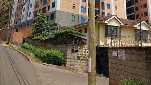 A multi-story residential building with a modern architectural design, featuring balconies and large windows. - DALM-D Cozy lovely studio with Gym in Kileleshwa (Nairobi)