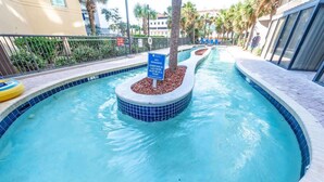 A swimming pool with a sign indicating no swimming in the lazy river.