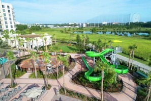 A water park with slides and a Ferris wheel in the background. - Orlando | Park Escape | Pool & Attractions | 2BR Plus (Orlando)