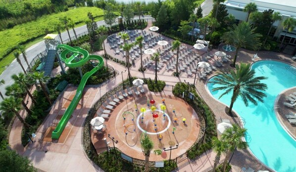 A resort with a pool, lounge area, and a water slide.