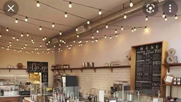 A coffee shop interior with a wooden counter, a menu board, and barista stations. - Local Host: 3BR 2.5BA by BSU DT GreenBelt & Skiing (Boise)