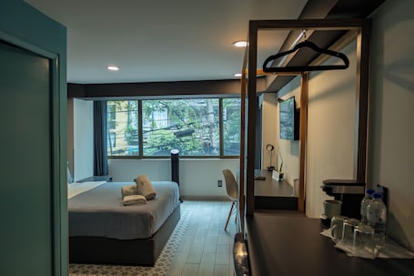 Elite Studio | Desk, laptop workspace, blackout drapes, iron/ironing board