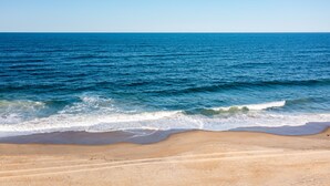 A beach with a clear view of the ocean and a sandy shoreline. - Ocean Views with a 1 minute walk to beach access! Linens & Bath Towels included! (Kill Devil Hills)
