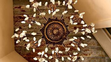 A chandelier with a central ornate design and multiple crystal elements.