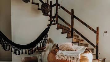 A staircase with wooden railings and a hammock.