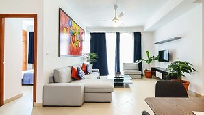 A modern living room with a sofa set, a dining table, and a flat-screen TV. - Spacious 2 Bedroom Apt @Prime-Location, Colonial Zone (OldTown) (Santo Domingo)