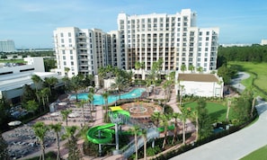 A hotel with multiple floors, a swimming pool, and a water park area. - Orlando | Theme Park Escape | Pool & Parks | 2BR Lockoff (Orlando)
