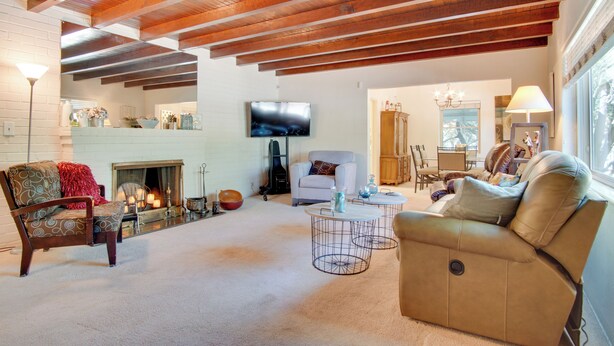 A spacious living room with a fireplace, a television, and comfortable seating. - 5 Mi to Dtwn: Tuscon Escape w/ Yard & Patio! (Tucson)