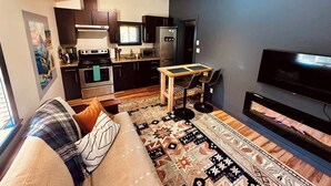A modern apartment with a living room, kitchen, and dining area.