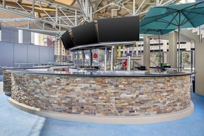 Relax and unwind at the outdoor bar, where guests can enjoy refreshing drinks and meals under shaded comfort.
