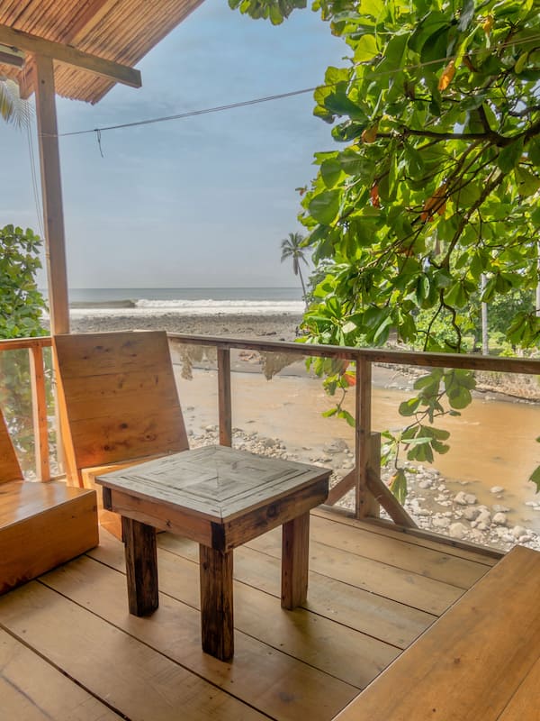 Enjoy the ocean view from this deck surrounded by lush greenery.