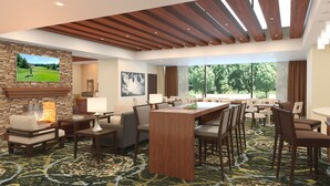 A hotel lobby with a large wooden reception desk, multiple seating areas, a fireplace, and a large window offering a view of trees. - 1 Bedroom | Free Daily Breakfast, Gym (Atlanta)