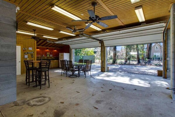 Enjoy dining al fresco in this covered outdoor space with a table and chairs.