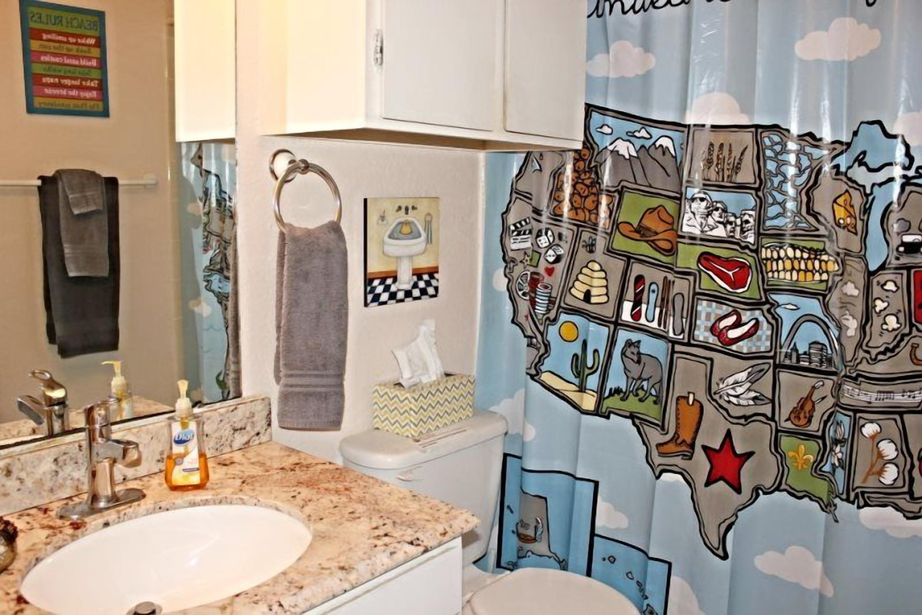 A bathroom with a sink, toilet, and towel rack.