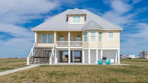 A two-story house with a front porch, a staircase, and a garage.