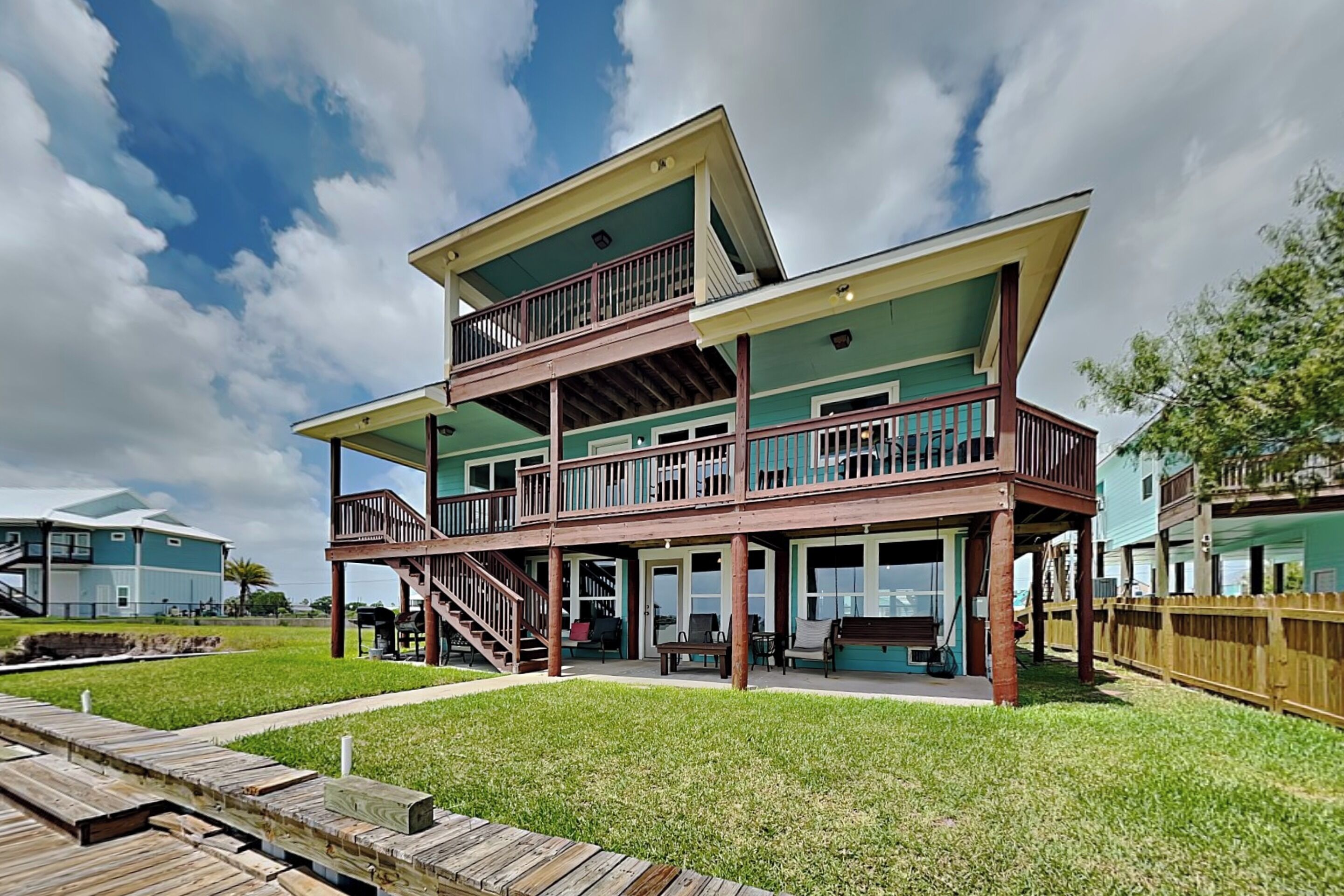 A two-story house with a balcony and a deck.