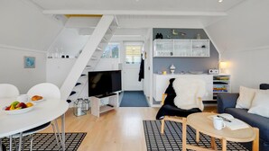A modern apartment with a dining area, a living room, a kitchen, and a staircase. - Beautiful home in Gedser with kitchen (Gedser)